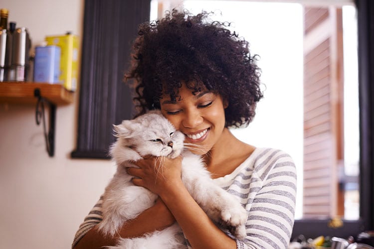 Pet Insurance: Woman Hugging Cat